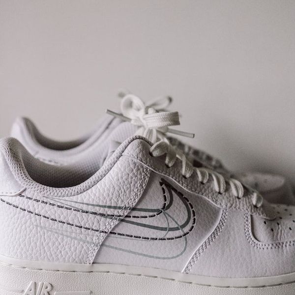 Close up of sports shoes on a white wooden floor.
