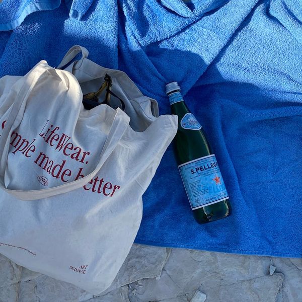 Water bottle and towel on a blue background.